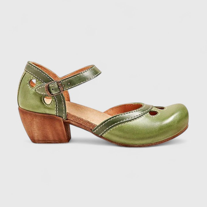 A woman in pastel pink and mint block heel sandals at a summer garden party.