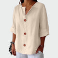 Cream relaxed-fit women's blouse with three-quarter sleeves and wooden front detail