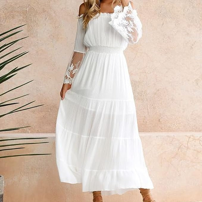 Woman wearing a romantic off-shoulder maxi dress with sheer embroidered sleeves at an evening celebration.