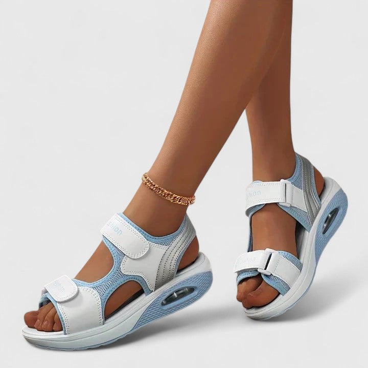 A woman in white sandals with a lilac trim walking comfortably, feet supported and light.