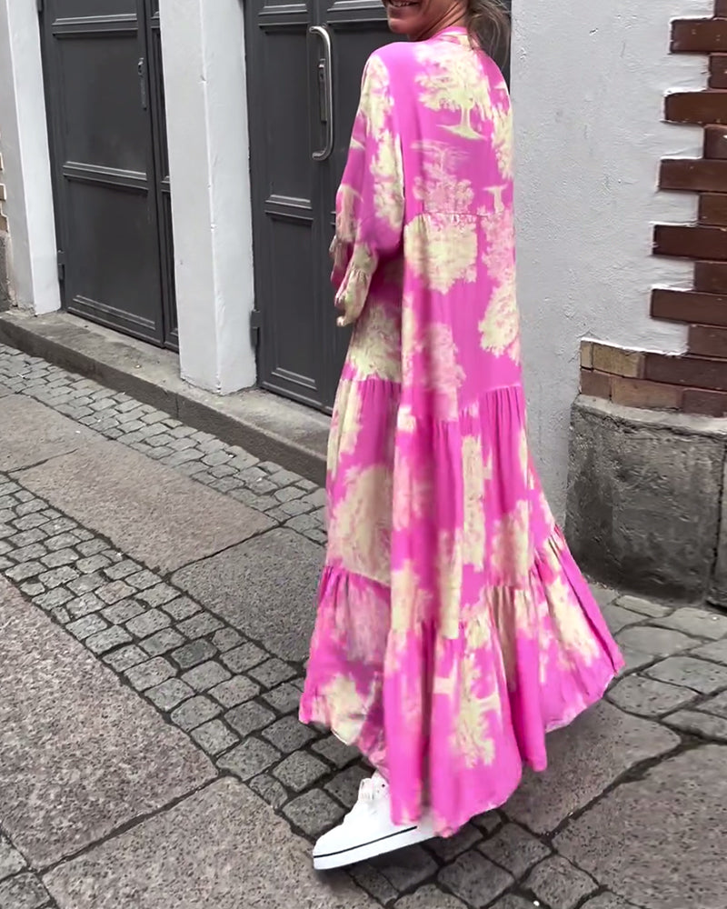 Woman wearing the Abigail flowing maxi dress with a delicate print and V-neckline, the skirt moving softly as she walks.