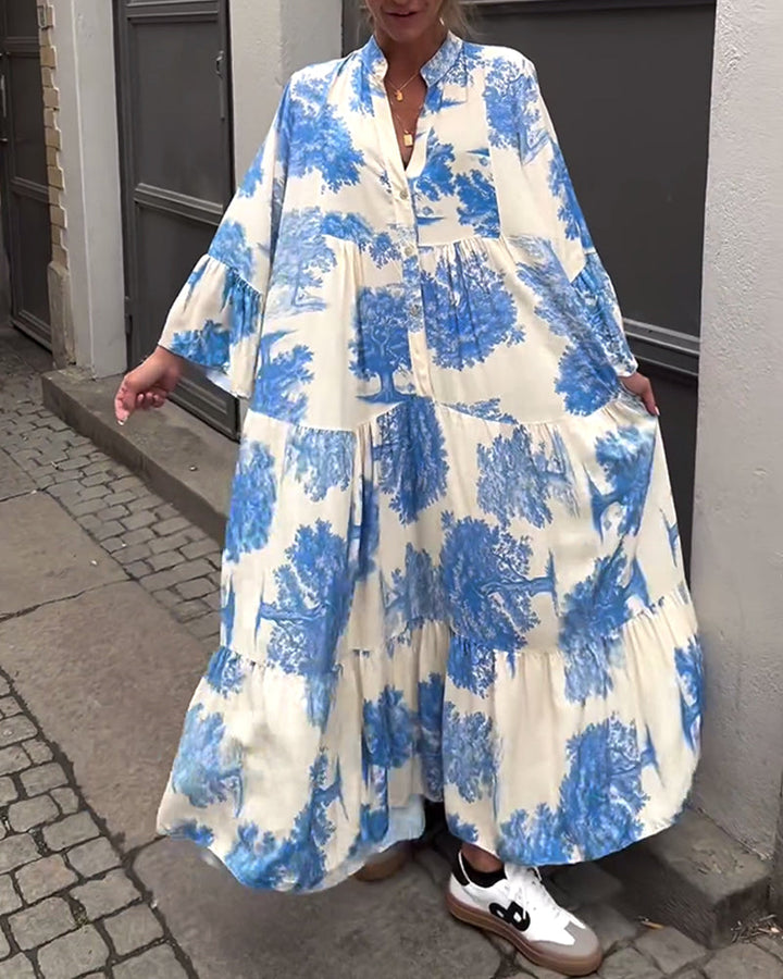 Woman wearing the Abigail flowing maxi dress with a delicate print and V-neckline, the skirt moving softly as she walks.