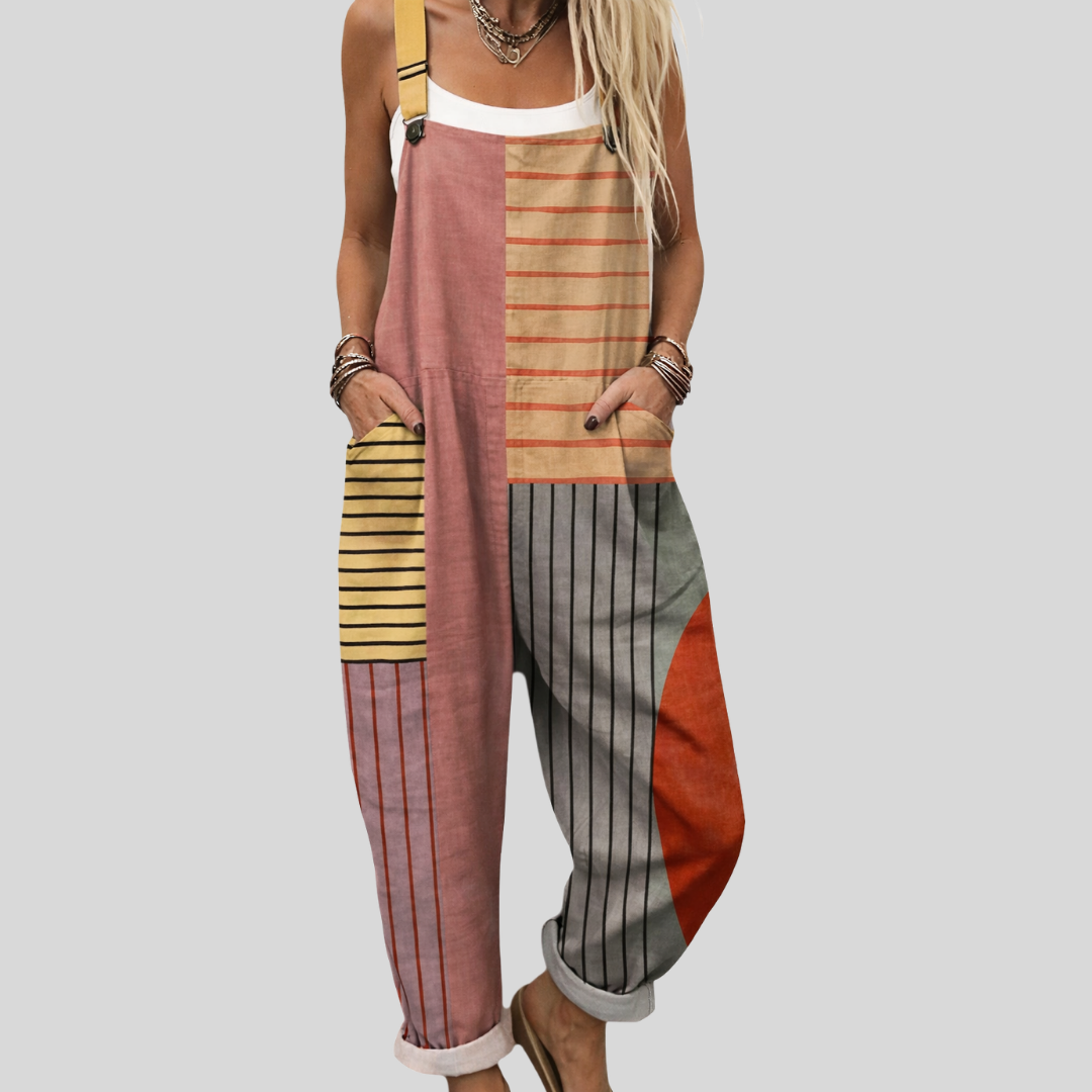 Woman wearing the Caoimhe™ harem-leg dungarees in a warm terracotta, dusty pink, yellow-stripe, and grey colour-block patchwork print.