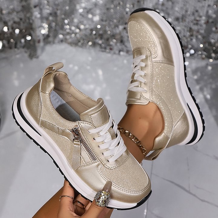 A woman in silver orthopaedic trainers with a handy side zip.