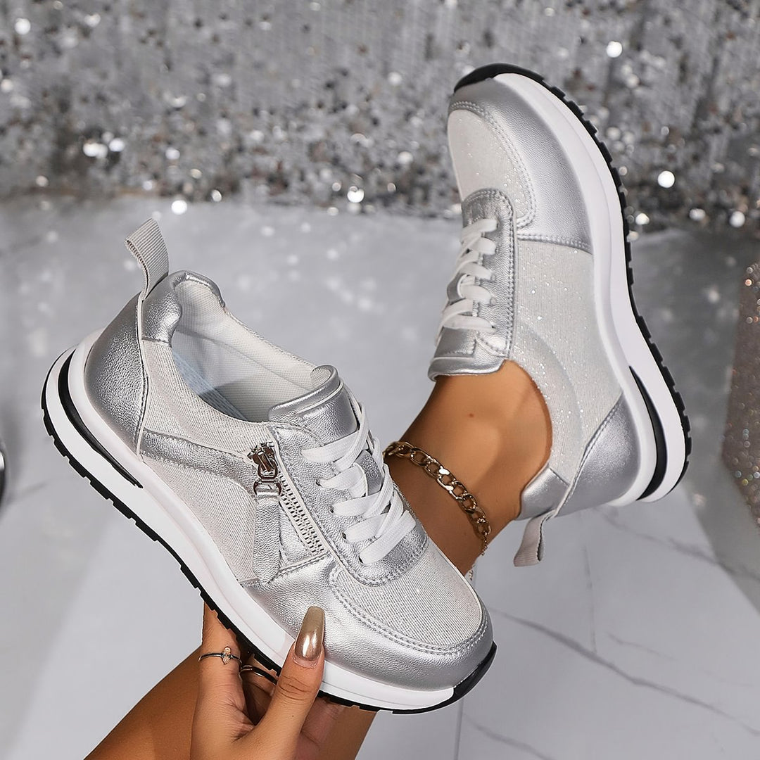 A woman in silver orthopaedic trainers with a handy side zip.
