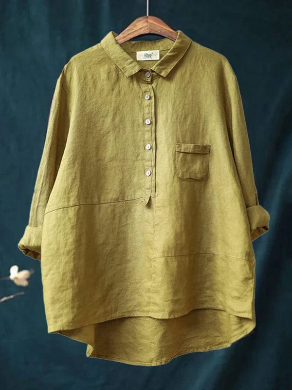 Woman wearing a flowing printed summer blouse that falls softly around her figure.