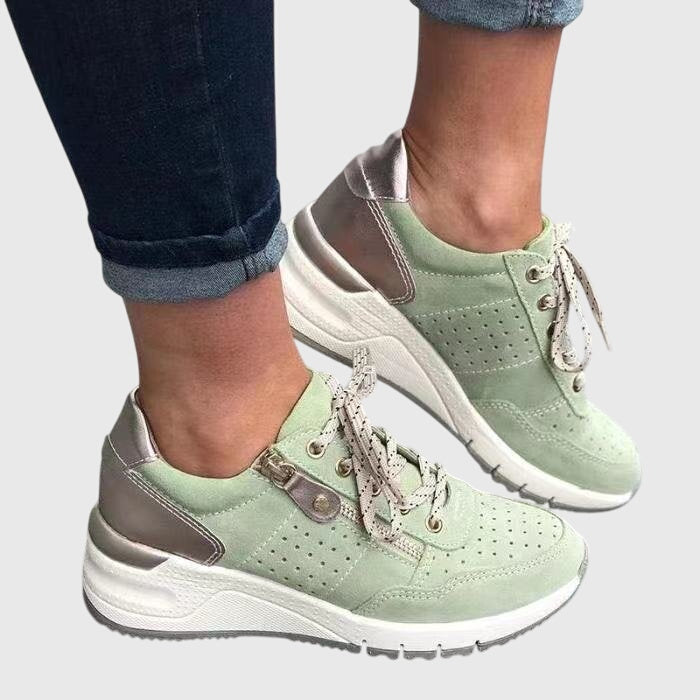 A woman on a walk wearing soft, supportive trainers on a bright day.