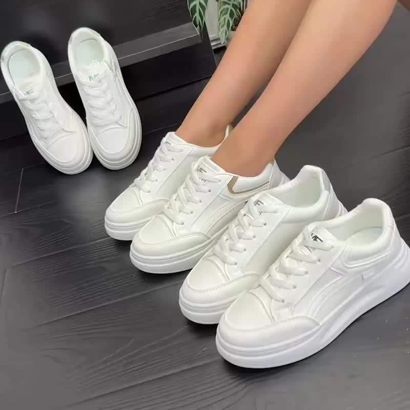 A woman in crisp white light comfort trainers paired with jeans.