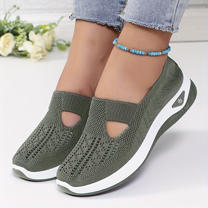 A woman stepping into easy slip-on comfort trainers with no laces.