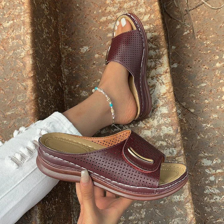 Open-work wedge sandals in bordeaux with a small metallic ornament on the upper