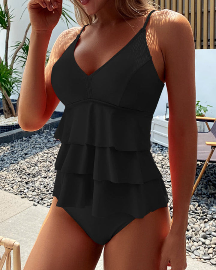 Light pink one-piece swimsuit with tiered ruffle frills on the front