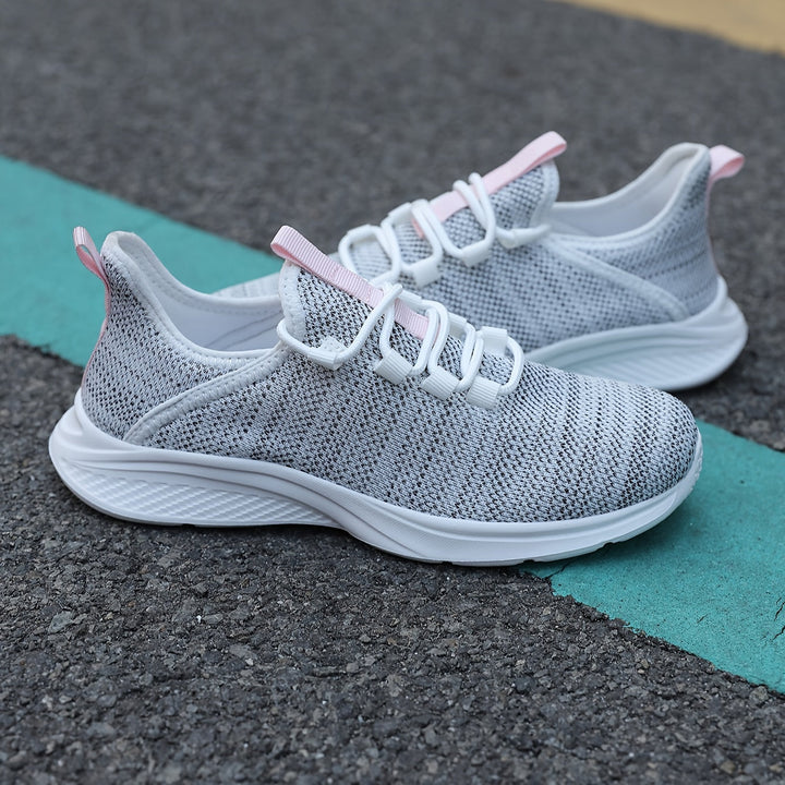 A woman walking comfortably in lightweight breathable trainers with trousers
