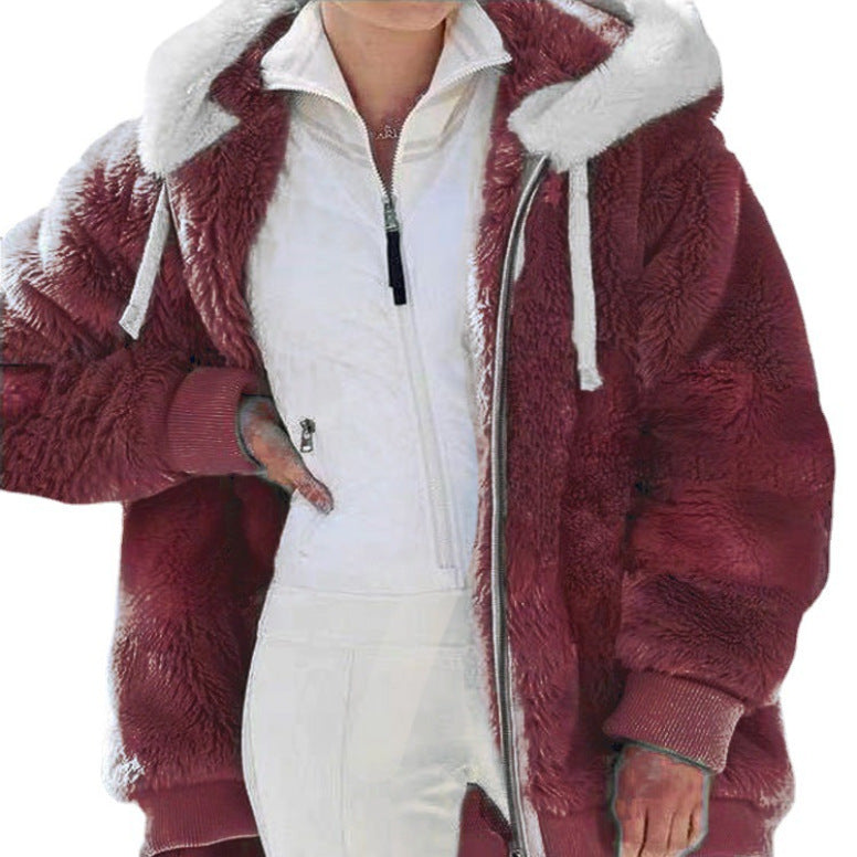 A woman wearing a hooded jacket with side pockets on a cold, rainy day out.