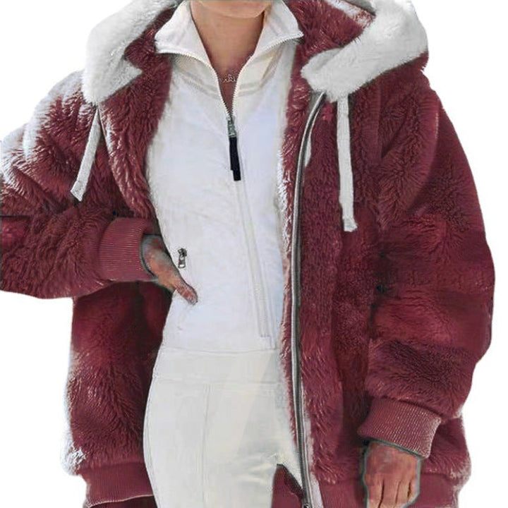 A woman wearing a hooded jacket with side pockets on a cold, rainy day out.