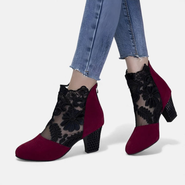 A woman wearing wide-toe orthopaedic heels, standing comfortably in an elegant everyday look.