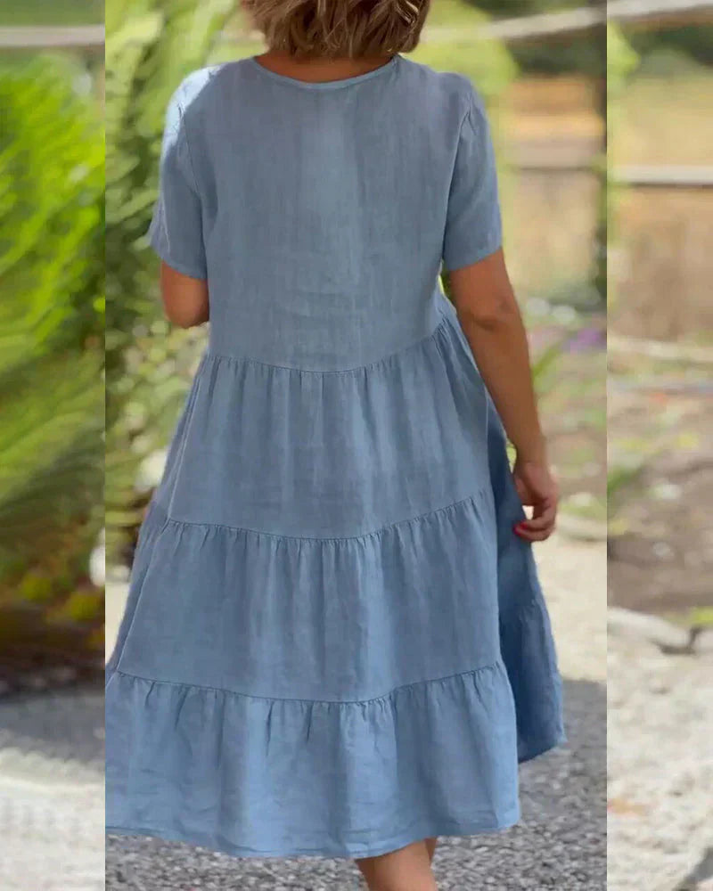 Woman wearing the Veronica™ V-neck summer dress with a soft layered skirt, strolling on a sunny afternoon.