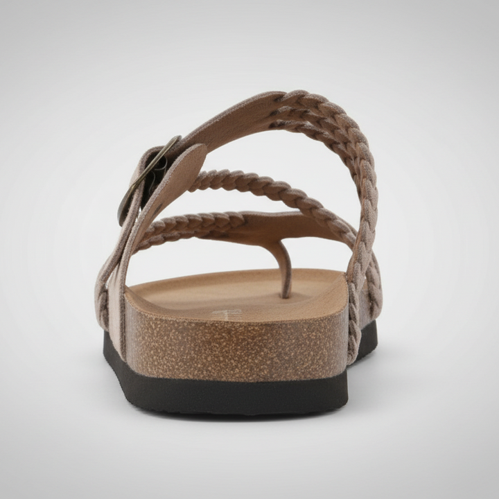 Natural woven flat sandal with an adjustable buckle strap and cushioned footbed