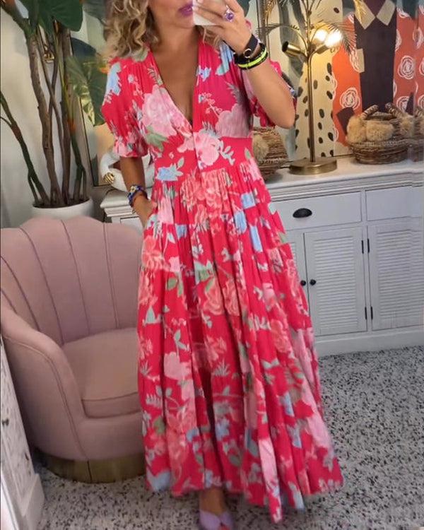 A woman wearing the Josephine bold floral maxi dress with a flowing full-length skirt at a garden gathering.