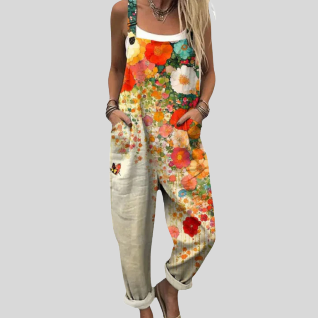 Woman wearing the Ciara™ wide-leg dungarees with an all-over bright orange and yellow poppy and daisy meadow print.