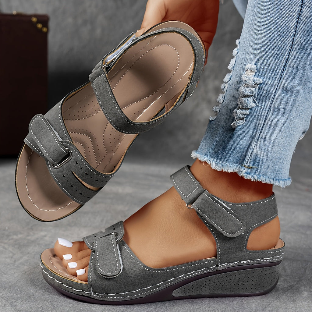 Wedge sandals with three adjustable velcro straps in a warm camel tone