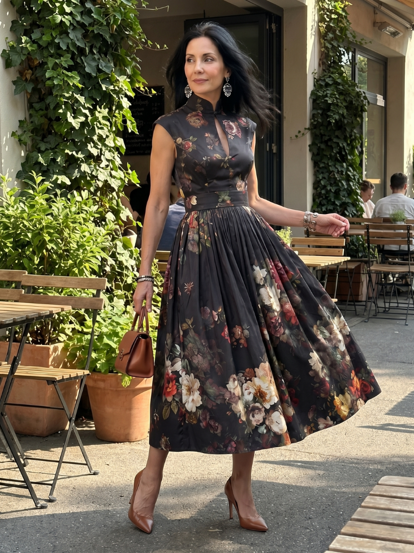 Black floral sleeveless midi dress with high neck and gently pleated skirt