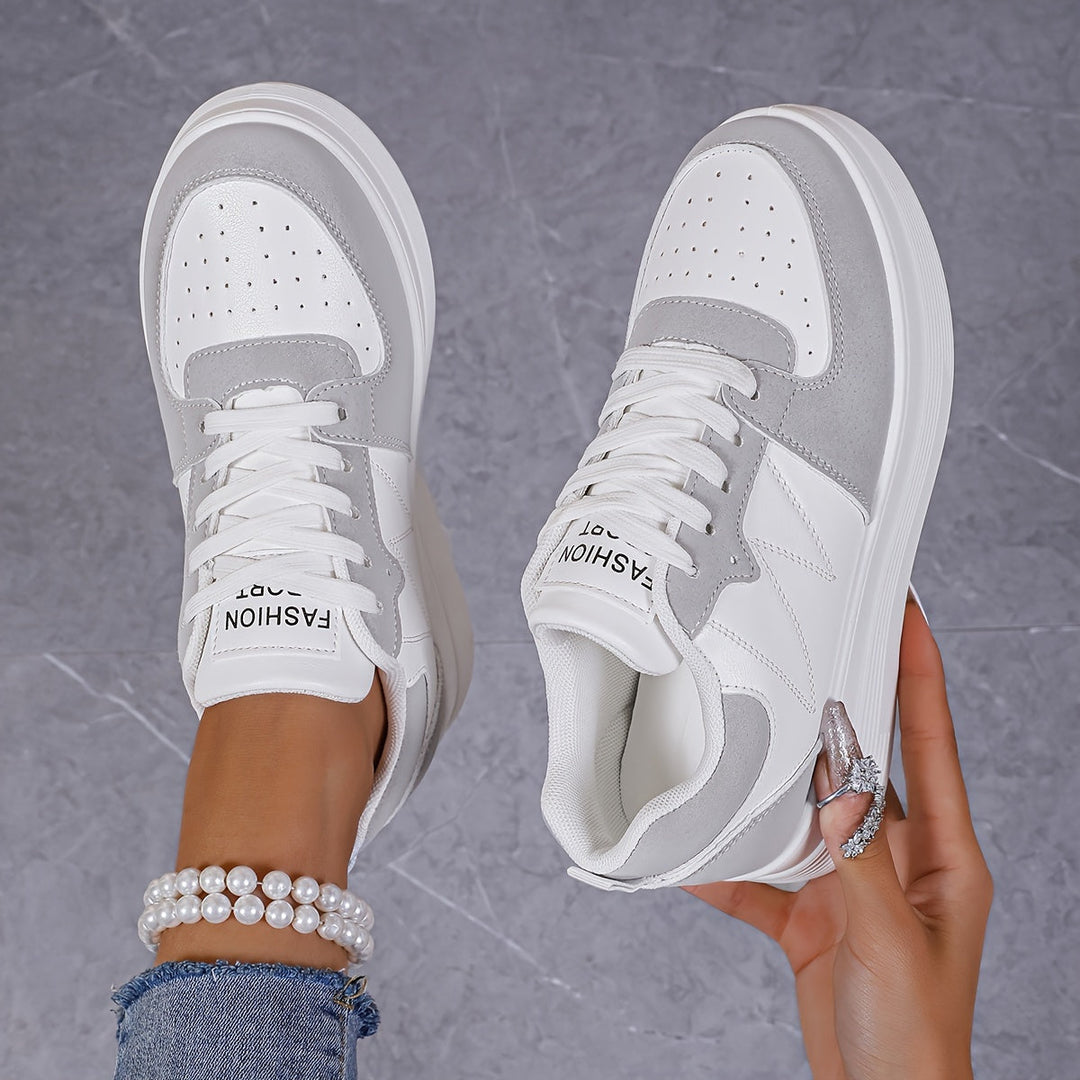 A woman wearing elegant two-tone platform trainers in the city