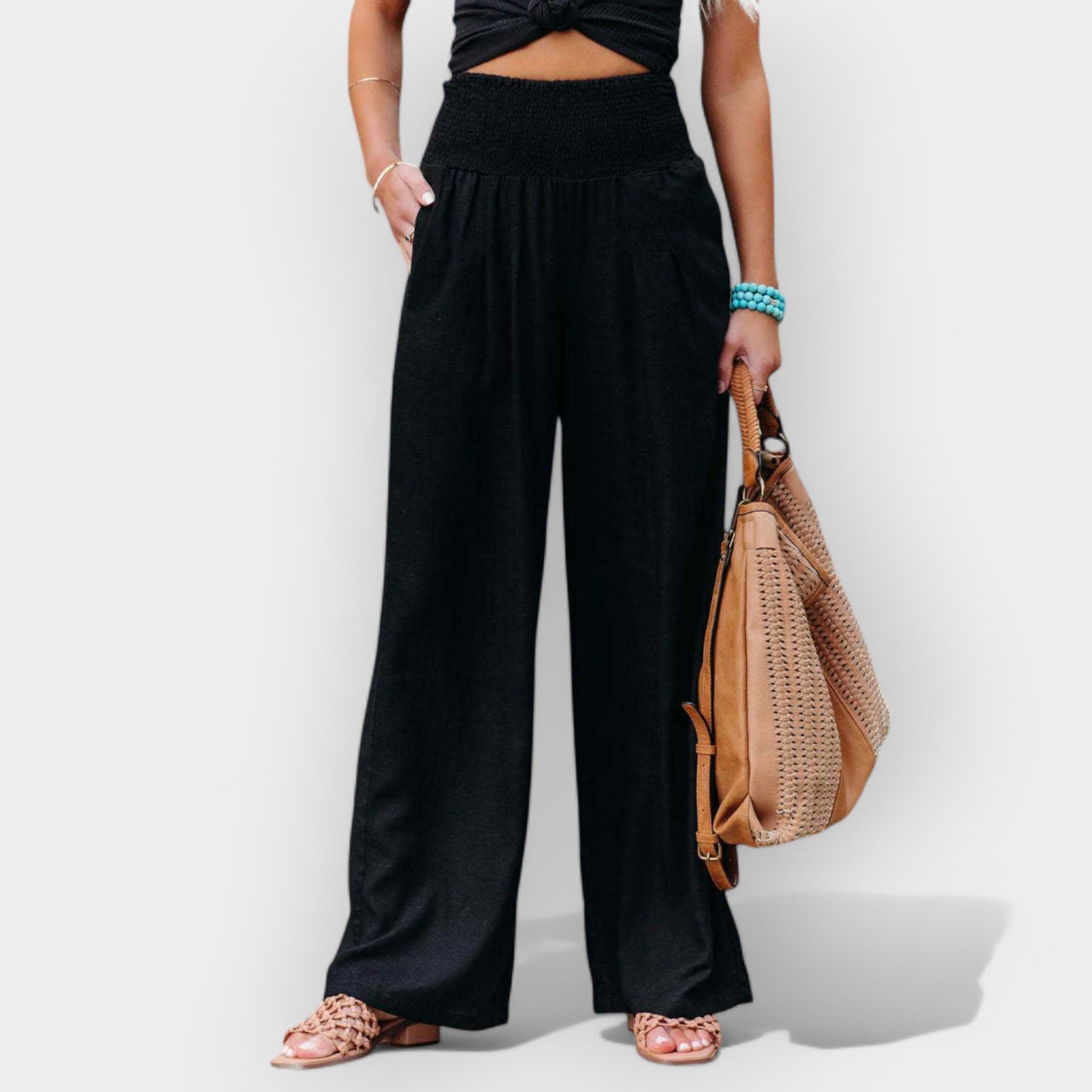 White wide-leg trousers with an elastic waist and a light, flowing silhouette