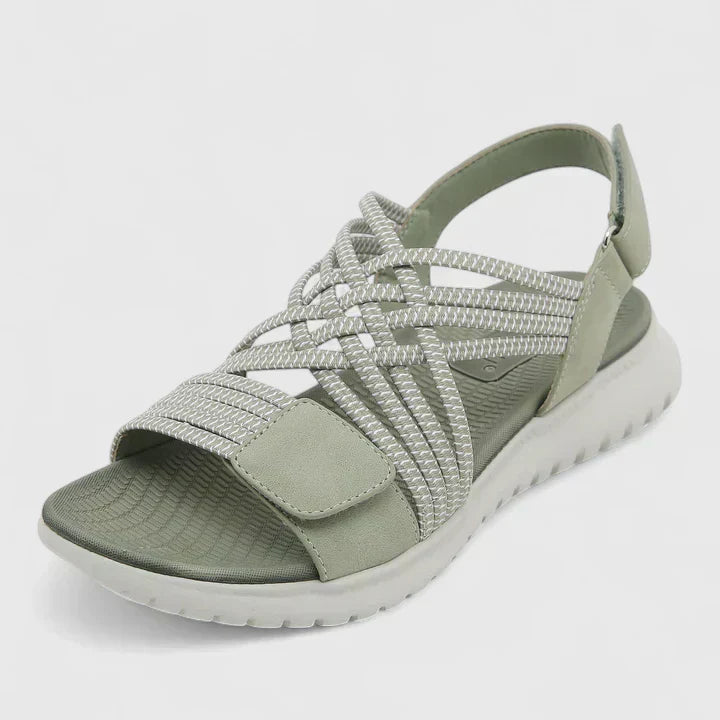 Blue open-toe sandals with woven stretch straps and a broad, cushioned white sole.