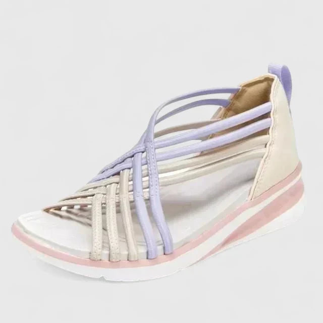 A woman walking with ease in elegant wide-fit everyday sandals with a cushioned footbed.