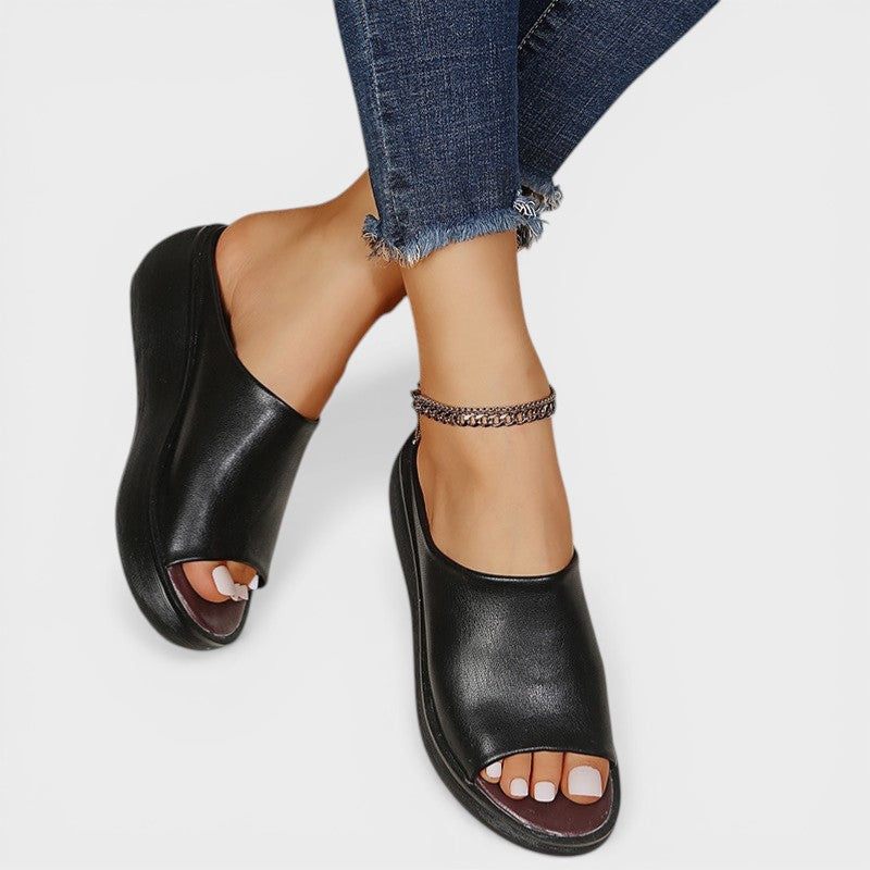 Open wedge mule sandals in white and brown with wide straps and a balanced wedge sole