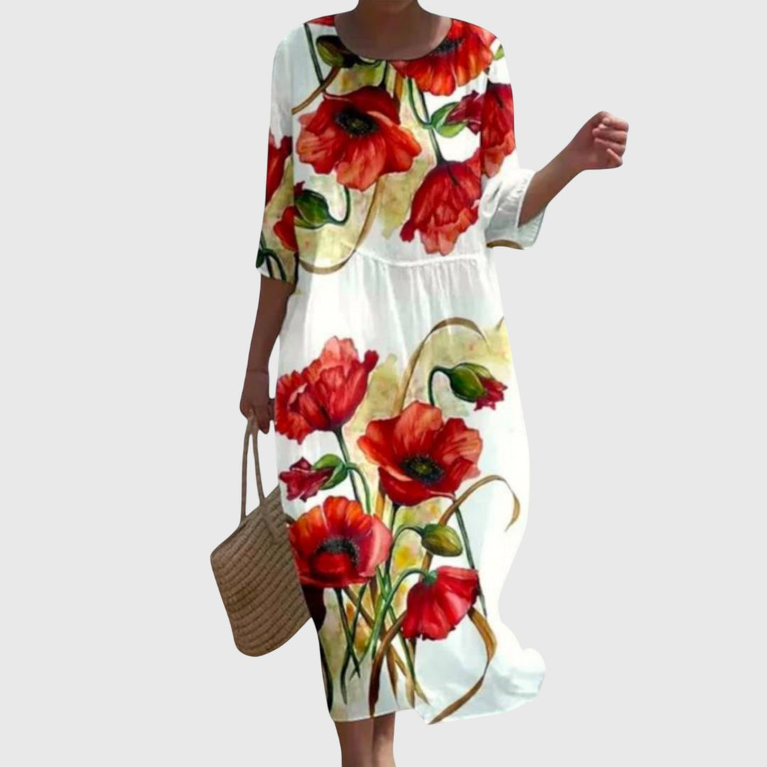 Woman wearing a long flowing maxi dress with a delicate floral print, moving gracefully.