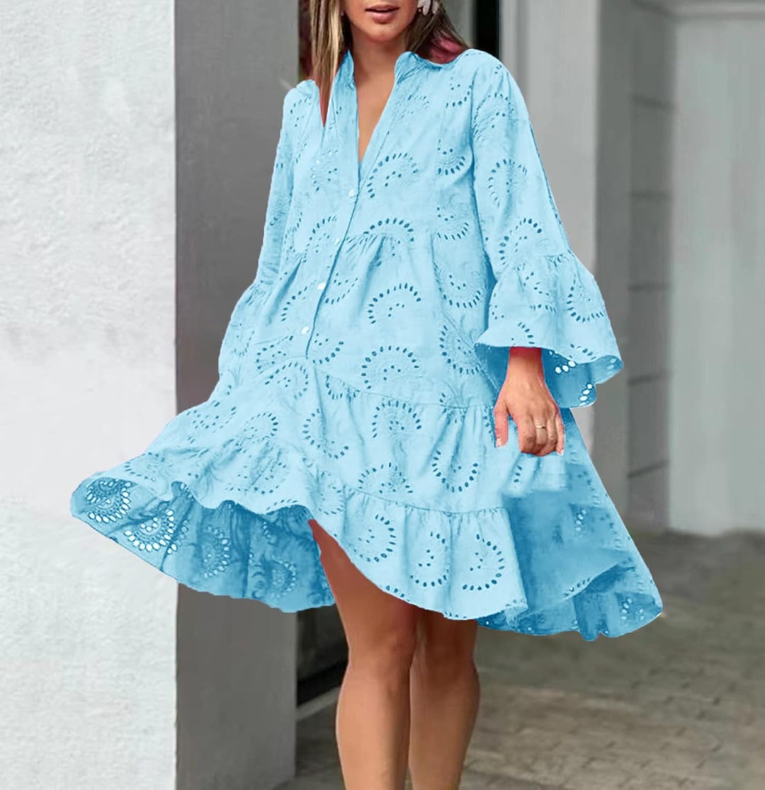 Woman in a breezy mini dress with delicate eyelet detailing and softly tiered skirt.