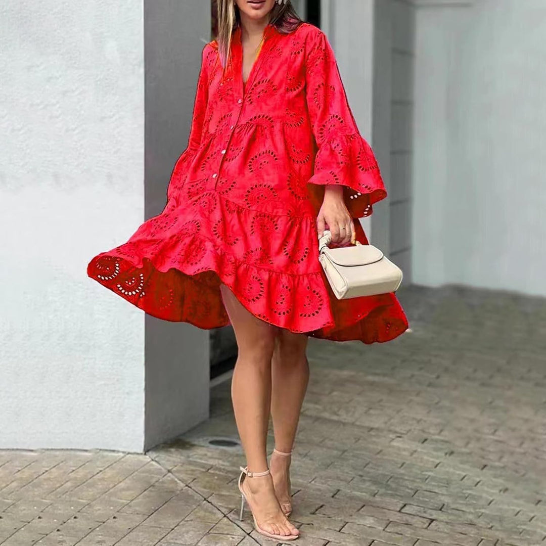 Woman in a breezy mini dress with delicate eyelet detailing and softly tiered skirt.