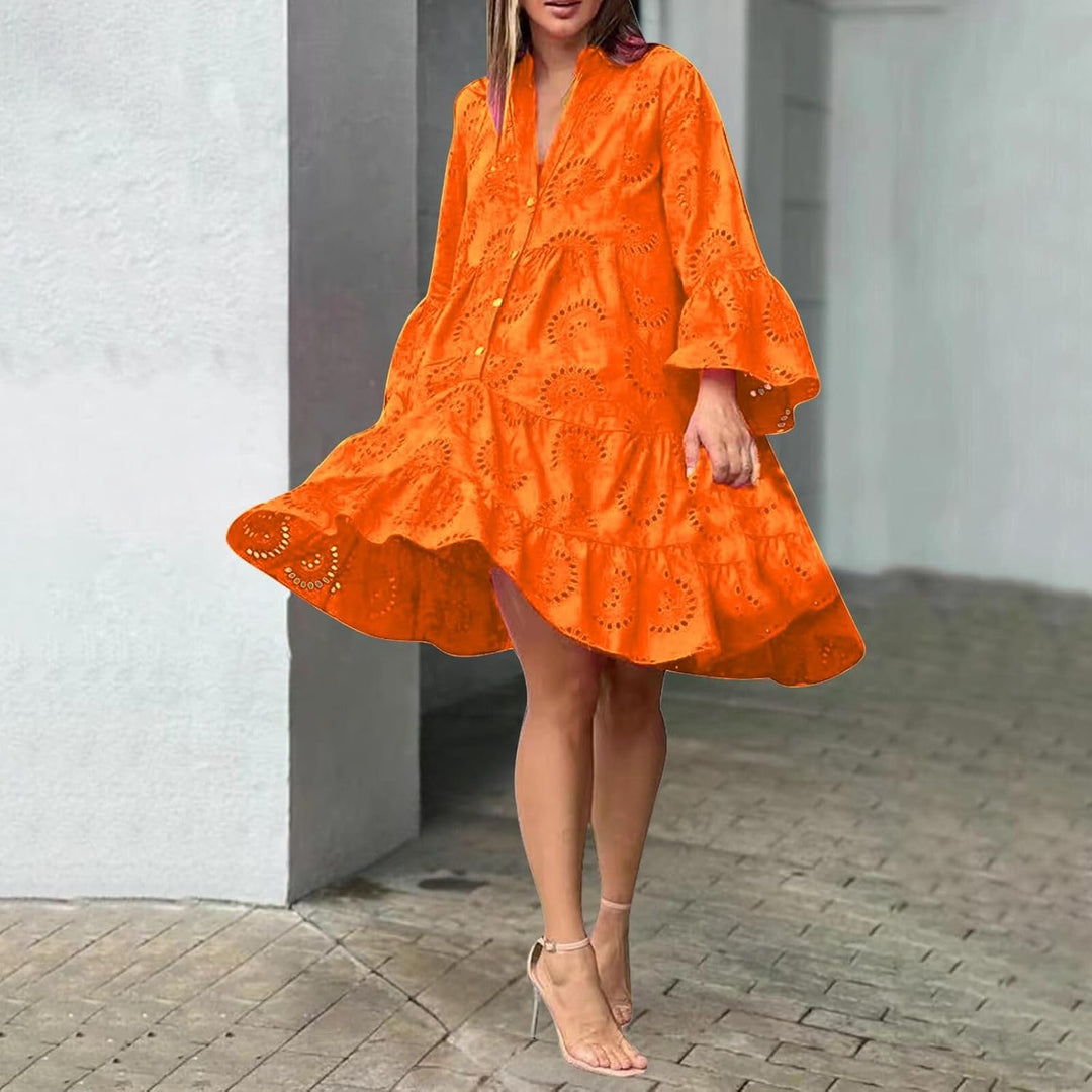 Woman in a breezy mini dress with delicate eyelet detailing and softly tiered skirt.