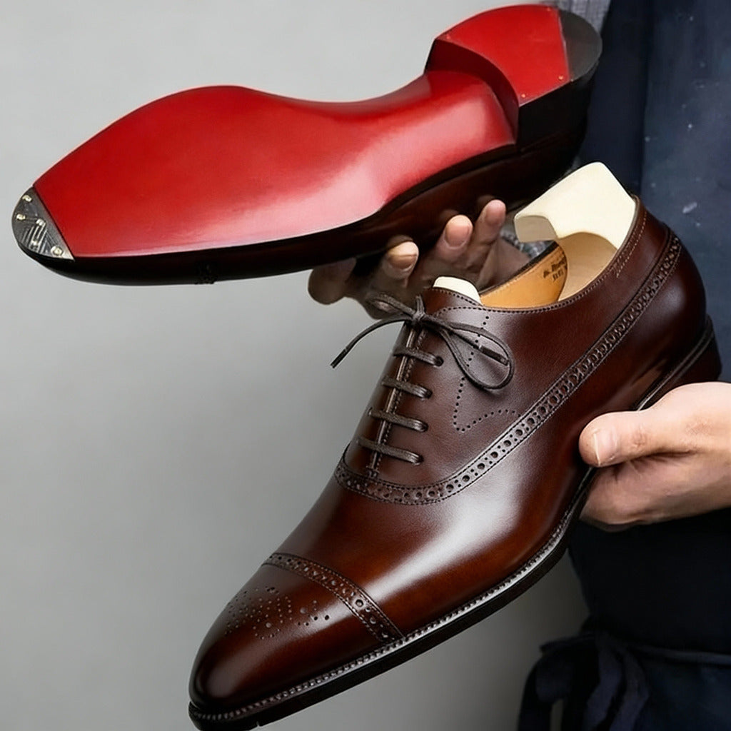 Men's black Oxford pointed-toe dress shoes with a clean structured silhouette and contrast sole