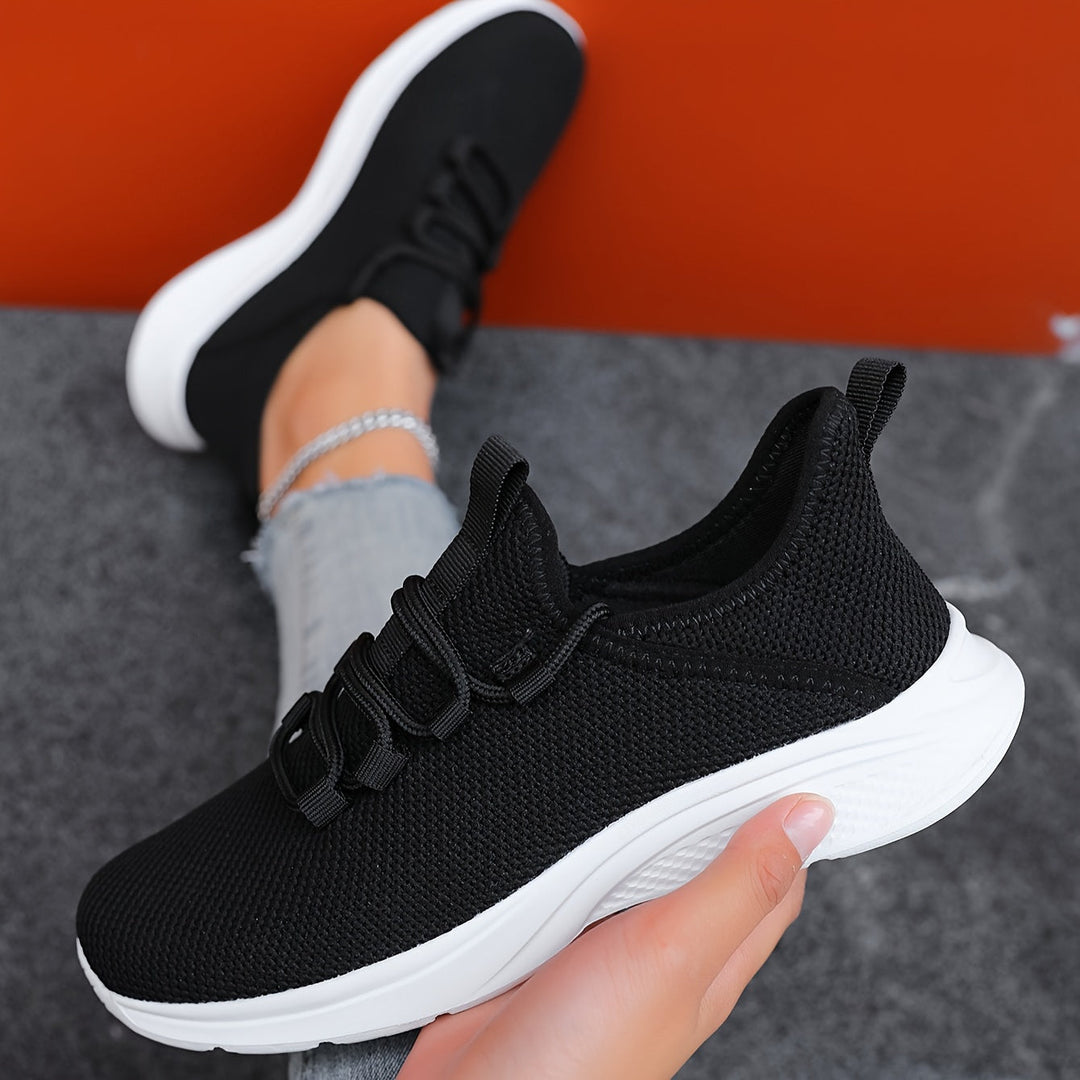 A woman walking comfortably in lightweight breathable trainers with trousers