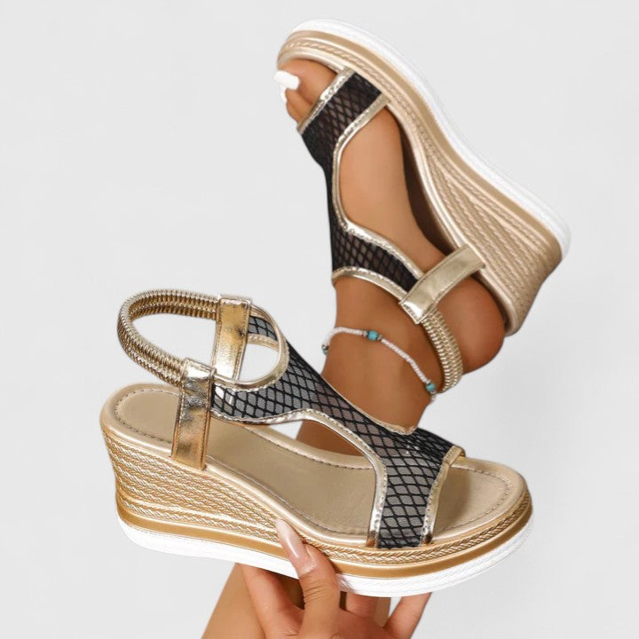 A woman wearing beige chic sandals with a cushioned sole and adjustable strap.