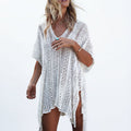 White openwork beach tunic worn as a cover-up over a swimsuit