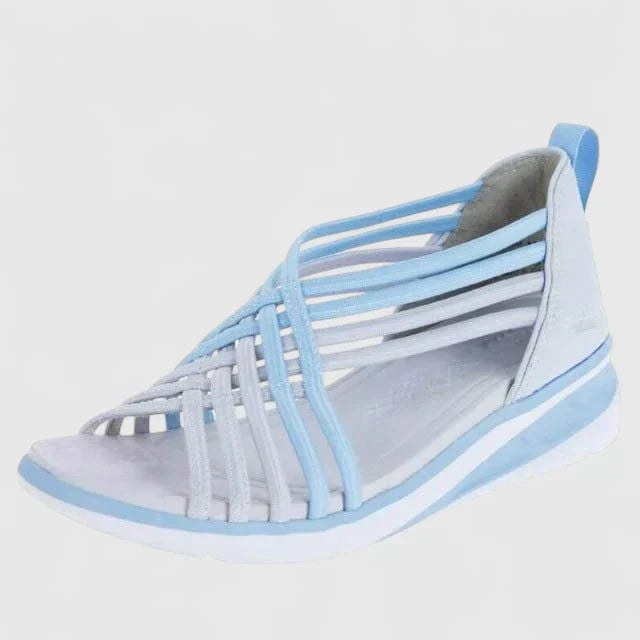 A woman walking with ease in elegant wide-fit everyday sandals with a cushioned footbed.