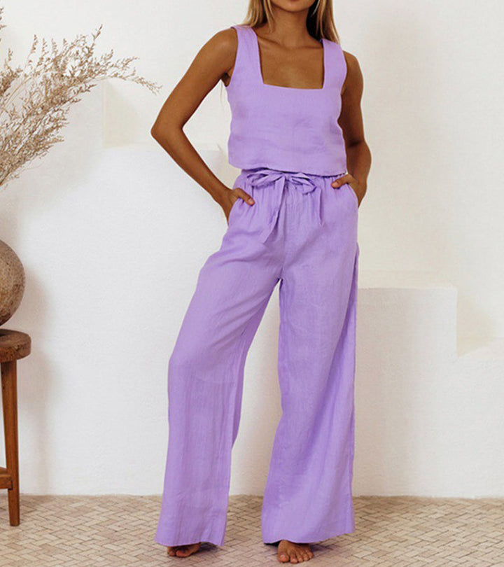 A woman wearing a minimal two-piece set with a square neckline and belted flared trousers.