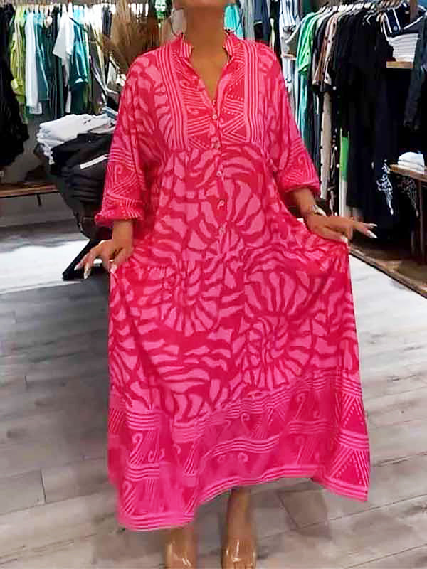 Woman wearing the Oonagh™ vivid printed maxi dress with a button front, standing confidently outdoors.