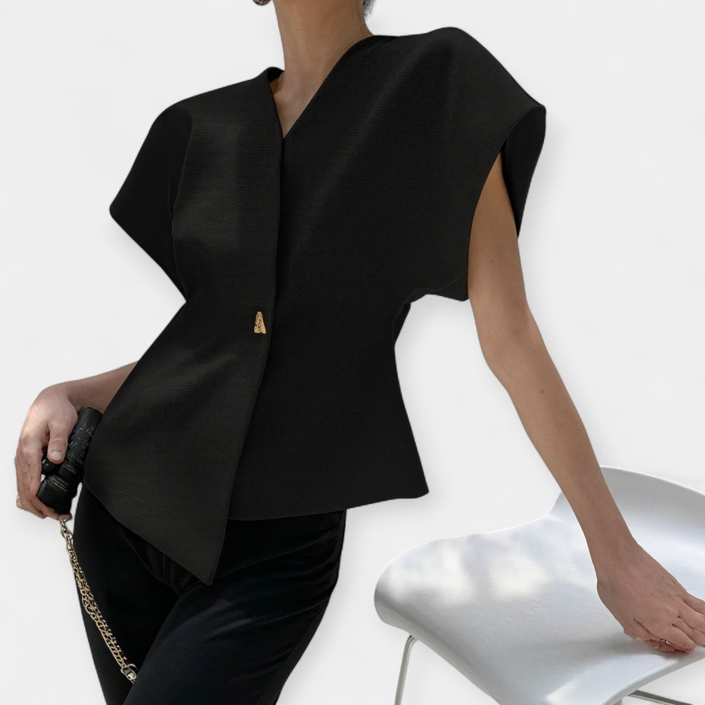 White structured minimalist top with clean lines and a quietly elegant silhouette