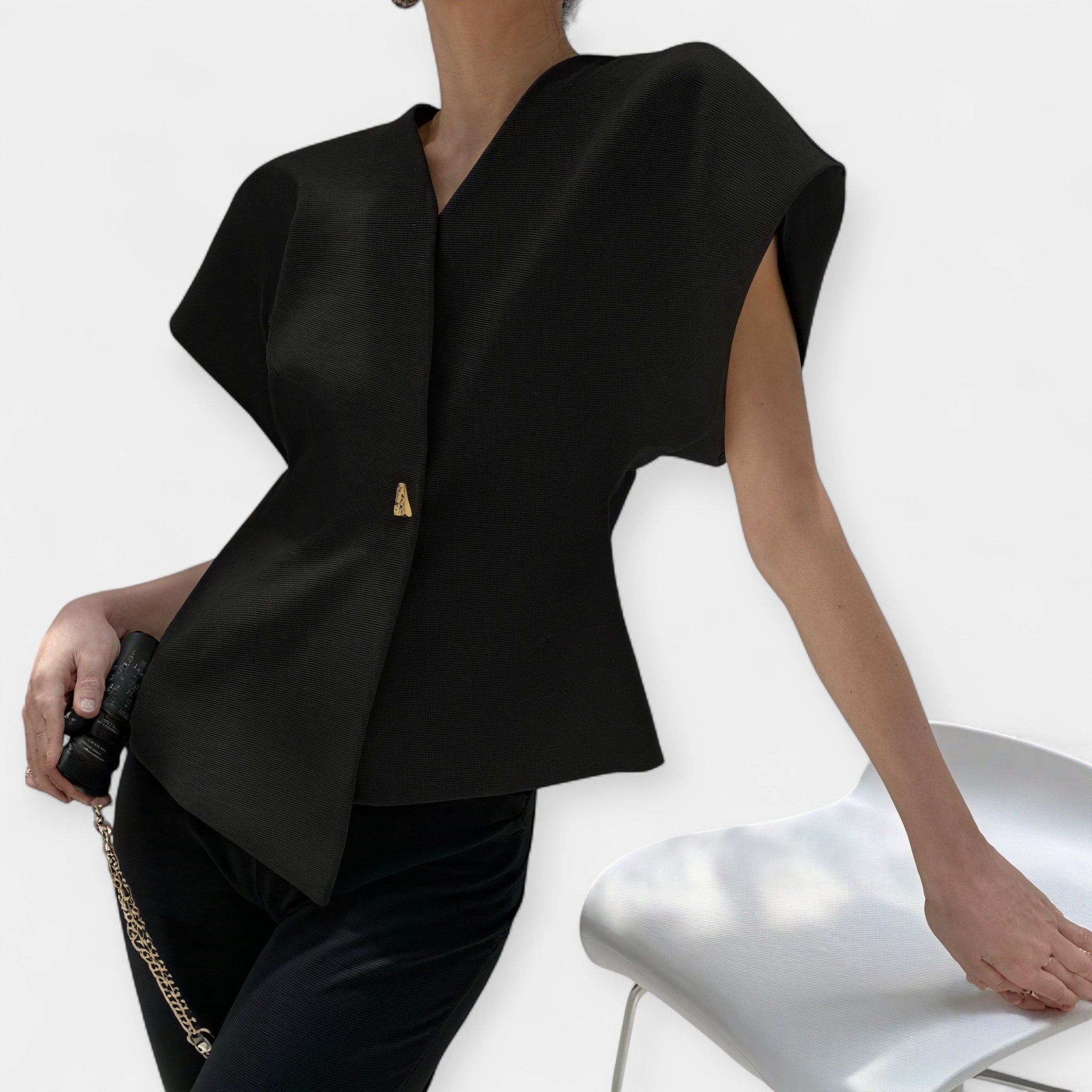 White structured minimalist top with clean lines and a quietly elegant silhouette
