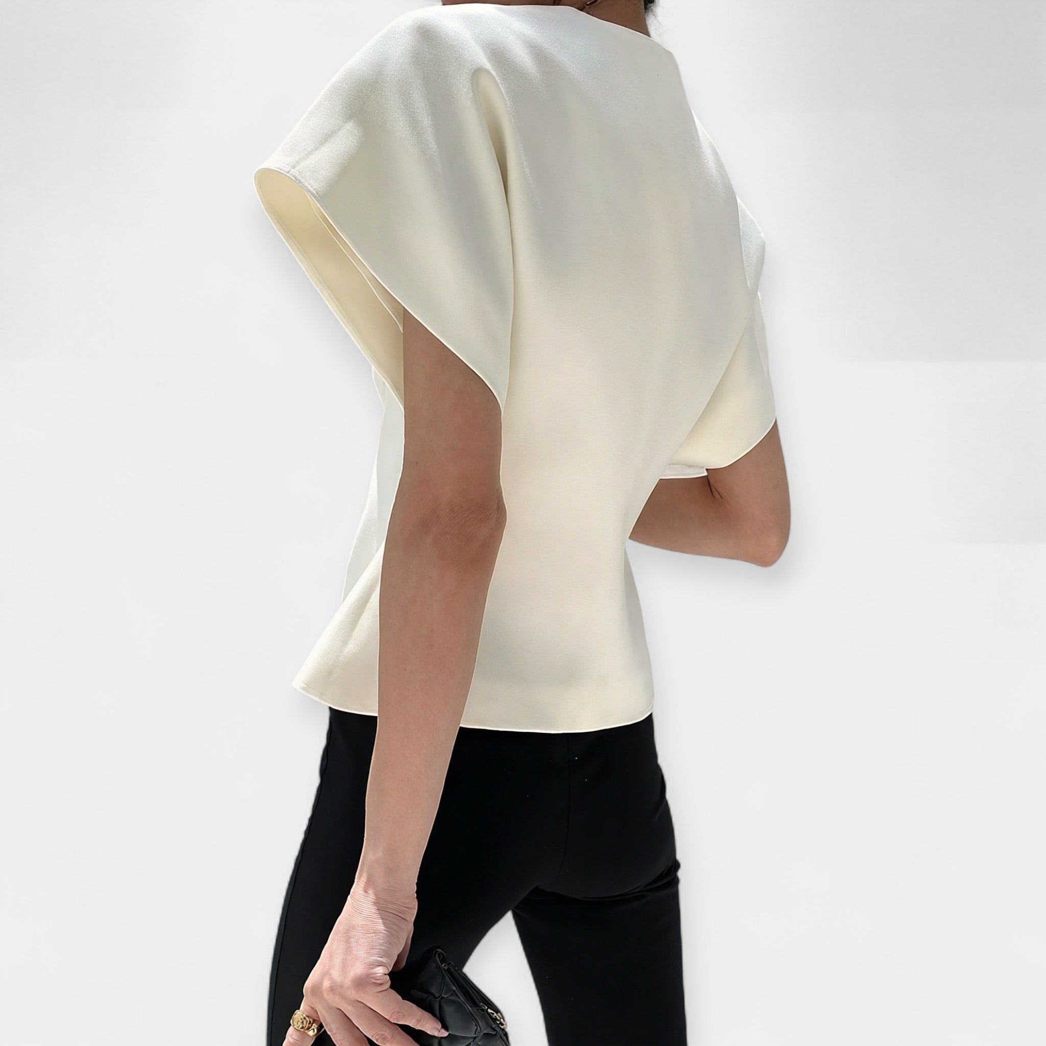 White structured minimalist top with clean lines and a quietly elegant silhouette
