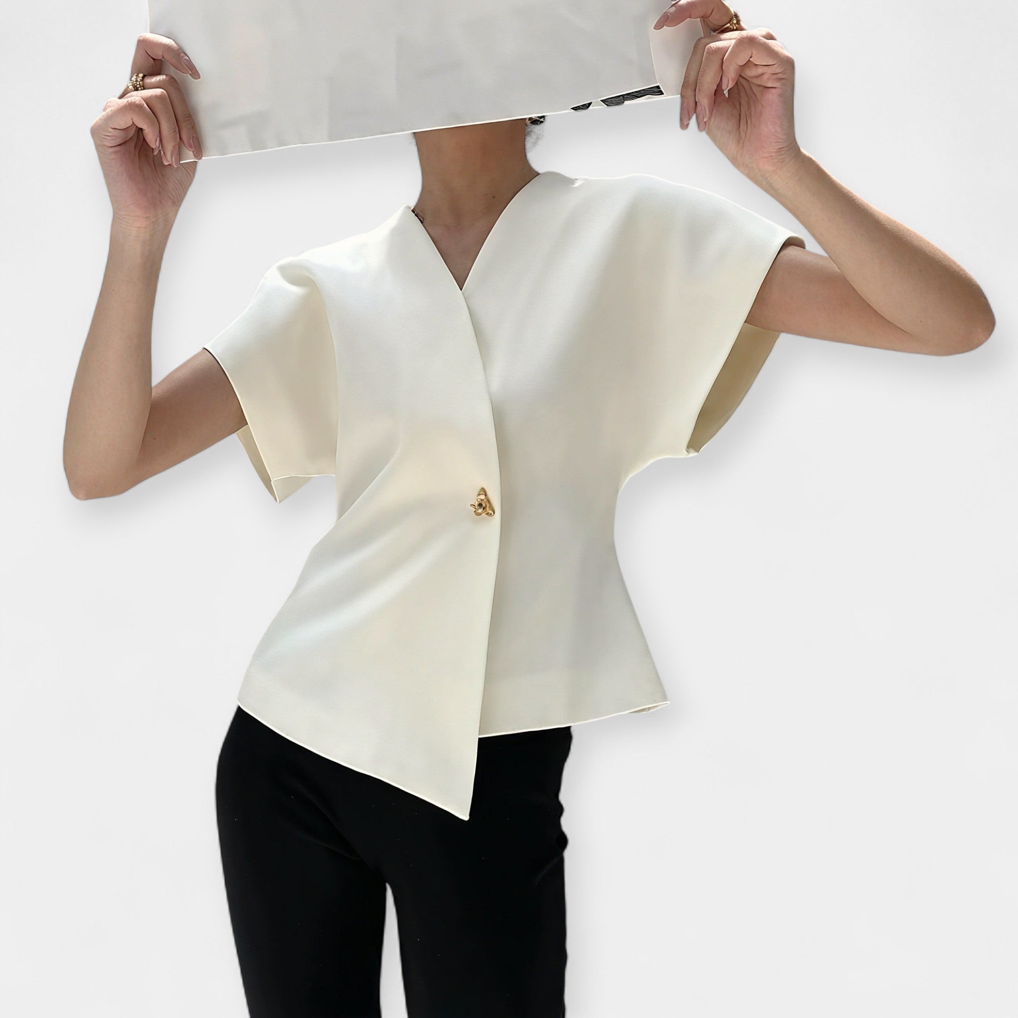 White structured minimalist top with clean lines and a quietly elegant silhouette