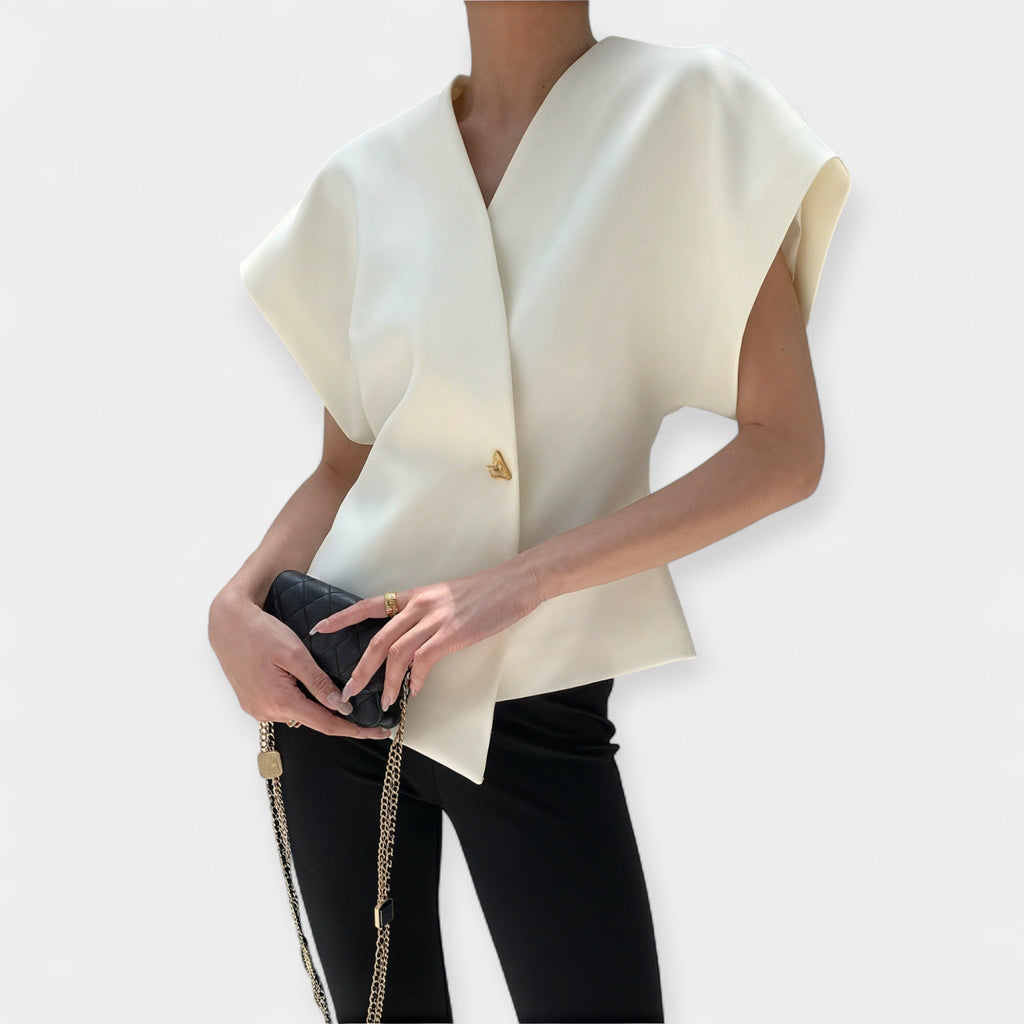 White structured minimalist top with clean lines and a quietly elegant silhouette