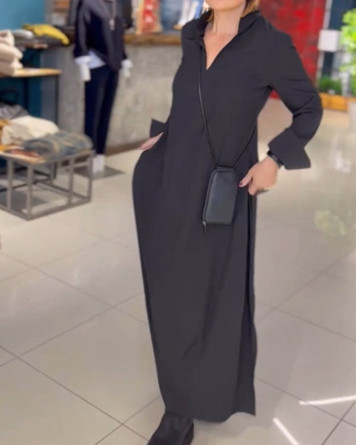Woman wearing the Sarah relaxed maxi dress with revere collar, standing by a doorway.