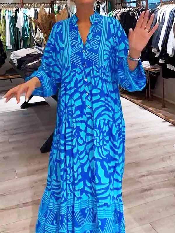 Woman wearing the Oonagh™ vivid printed maxi dress with a button front, standing confidently outdoors.