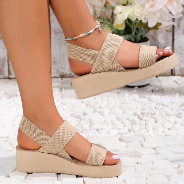 Platform sandals with double elastic straps in beige, offering a comfortable lift