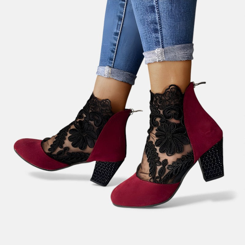 A woman wearing wide-toe orthopaedic heels, standing comfortably in an elegant everyday look.